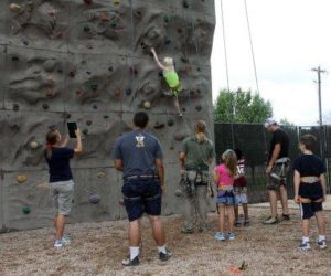 Young scholars rock climbing.