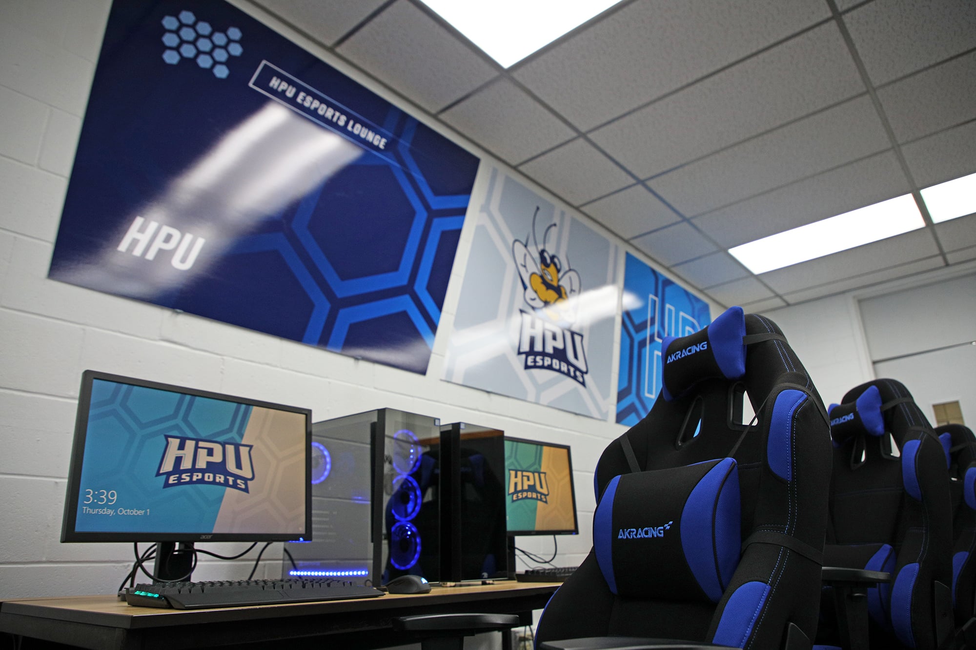 An esports gaming setup at Howard Payne University with branded chairs and computer screens. | HPU