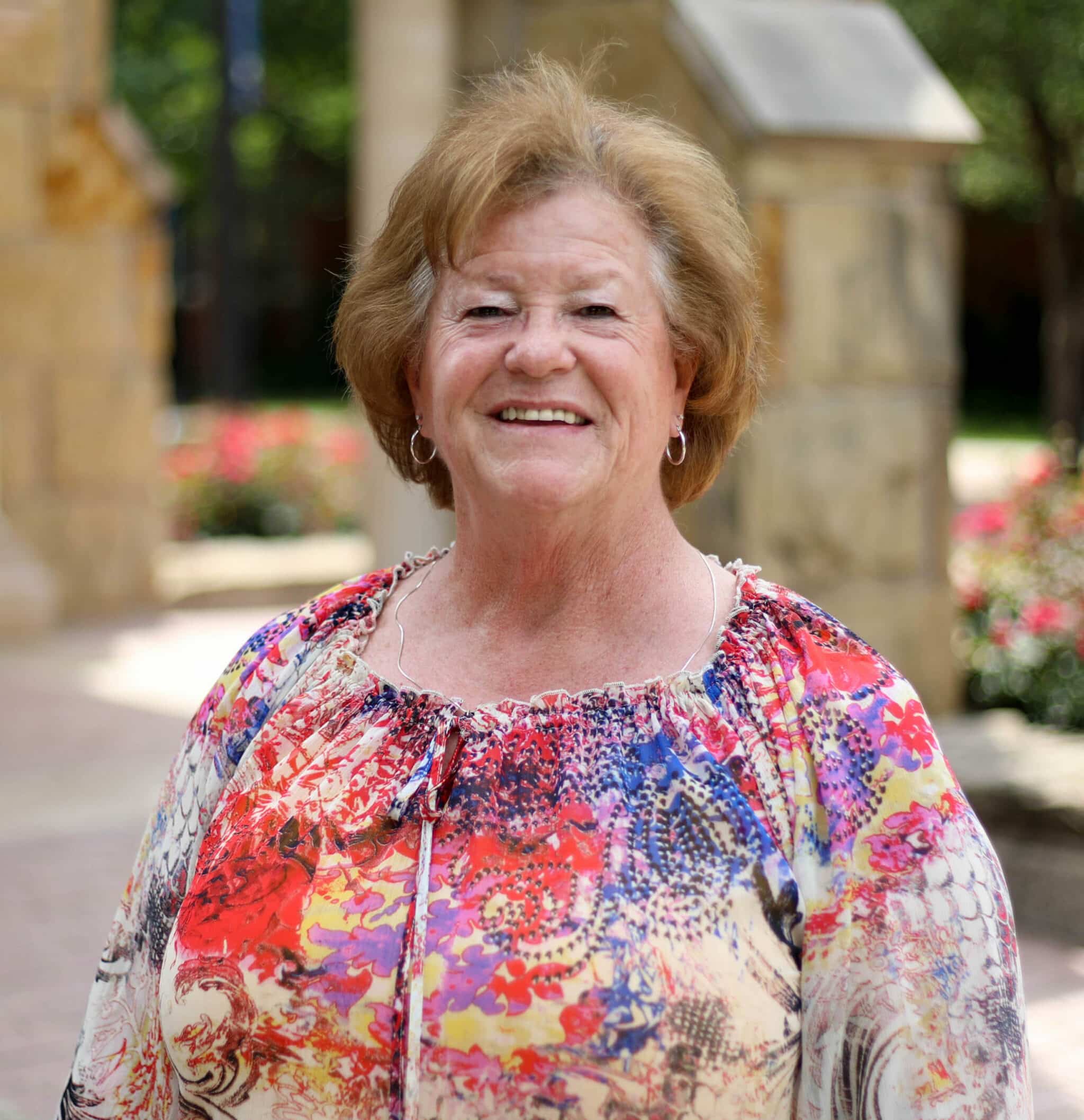 An elderly woman smiling outdoors at Howard Payne University. | HPU