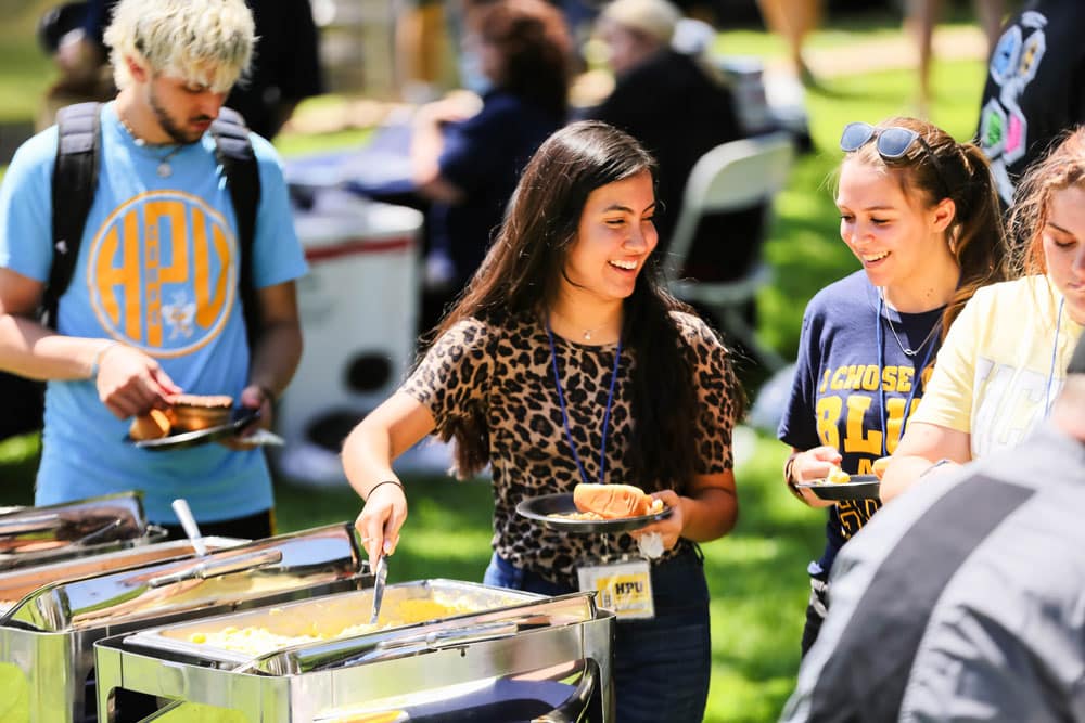 Students serving themselves food at an outdoor Howard Payne University event. | HPU