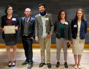 Five professionals from Howard Payne University posing with a certificate at an event. | HPU
