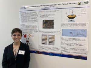 Woman presenting scientific research on bioremediation with fungi at Howard Payne University's conference or academic event. | HPU