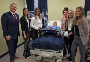 Group of people with a medical training mannequin in a clinical setting at Howard Payne University. | HPU