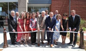 Group of individuals at a ribbon-cutting ceremony for a new building at Howard Payne University. | HPU