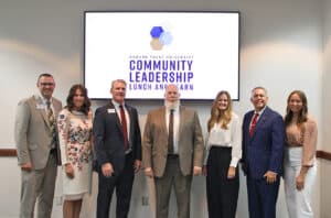 Group of seven individuals posing for a photo at Howard Payne University's community leadership event. | HPU