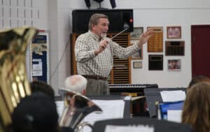 A conductor from Howard Payne University leading a music ensemble during rehearsal. | HPU