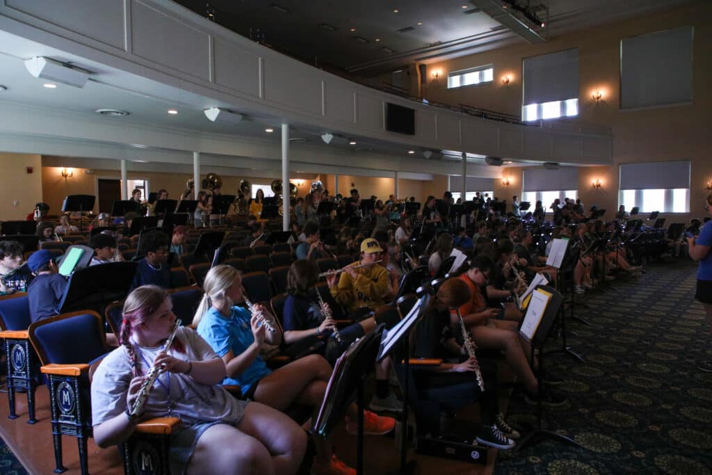 Campers gather in Mims Auditorium to rehearse music as a band.