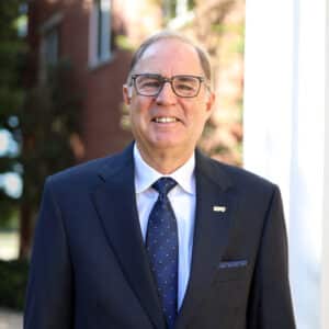 Lonn Reisman, HPU's assistant to the president for special projects, stands in front of the Mabee University Center.